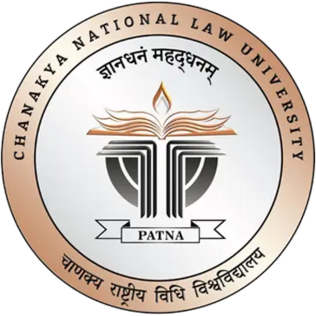 Circular emblem of Chanakya National Law University, Patna, featuring an open book with a flame above it and a scales motif, surrounded by the university's name in English and Hindi.